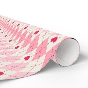May include: Pink and white wrapping paper with a pink and white argyle pattern and red hearts.