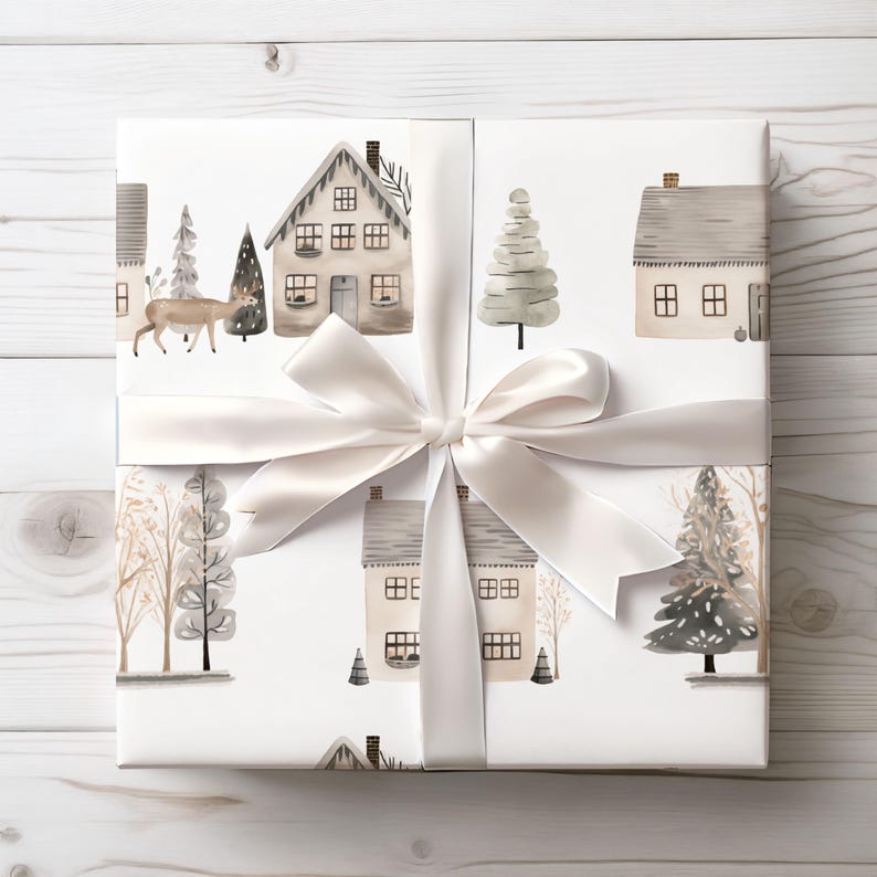 May include: White gift wrap with a repeating pattern of watercolour houses, trees, and a deer. The wrap is tied with a white satin ribbon and bow. The houses have grey roofs and are surrounded by winter trees.