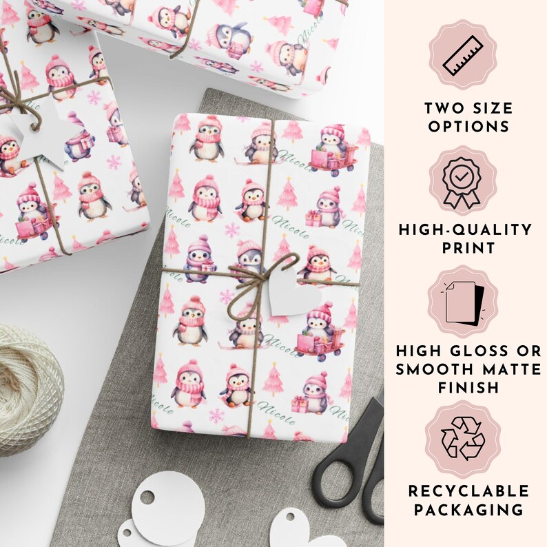 May include: White wrapping paper with a repeating pattern of penguins wearing pink hats and scarves, with pink Christmas trees. The text "Nicole" is printed on the paper. The image also shows the text "Two Size Options", "High-Quality Print", "High Gloss or Smooth Matte Finish", and "Recyclable Packaging".