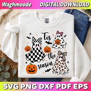 Könnte beinhalten: Ein weißes Sweatshirt mit einer Grafik aus drei Geistern mit Schleifen, orangefarbenen Kürbissen und schwarzen Fledermäusen. Der Text lautet Tis the season. Ein Geist hat ein schwarz-weißes Karomuster, einer schwarze Punkte und einer Leopardenmuster.