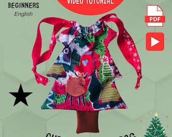 May include: A Christmas tree-shaped bag with a red, green, and white patchwork design. The bag features a brown trunk and red ribbon ties. The image includes the text "FOR BEGINNERS English", "PDF PATTERN VIDEO TUTORIAL", and "CHRISTMAS TREE BAG".