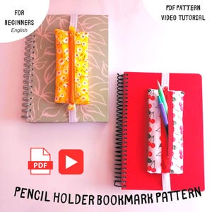 May include: Two spiral-bound notebooks, one grey with a floral pattern and one red, each with a fabric pencil holder. The yellow pencil holder has a daisy pattern, and the red one has a cherry pattern. Text reads: "FOR BEGINNERS English" and "PENCIL HOLDER BOOKMARK PATTERN."
