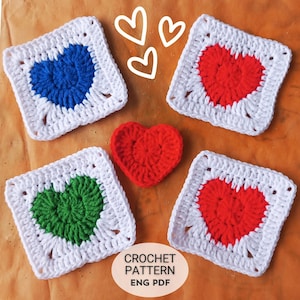 May include: A collection of handmade crochet items featuring heart designs. The image includes four white square crochet pieces with blue, red, and green hearts, along with a separate red heart. The text "CROCHET PATTERN ENG PDF" is also visible.
