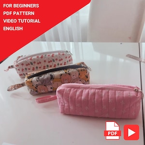 May include: Three pencil cases with different patterns are displayed on a white surface. One case has a cherry pattern, another has a bear and animal pattern, and the third is pink with a floral design. Text in the image reads: FOR BEGINNERS, PDF PATTERN, VIDEO TUTORIAL, ENGLISH.