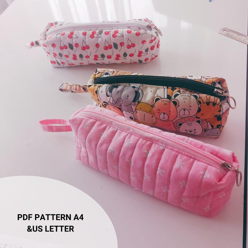 Handmade quilted glasses case with flap, beginner sewing project. Soft padded fabric eyeglass pouch with lining, quilted texture, and secure flap closure. PDF sewing pattern sample shown, protective sunglasses case, cute fabric craft gift idea.