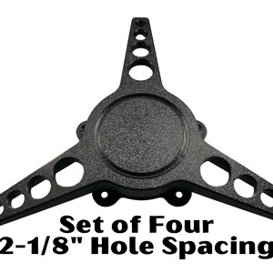 May include: Set of four black wheel spacers with a 2-1/8" hole spacing.