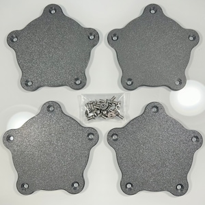 May include: Four grey, star-shaped metal plates with five holes each, arranged in a square. A small bag of silver screws is in the centre. The plates have a textured surface, likely components for a larger item.