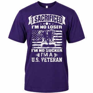 May include: Purple t-shirt with white text and a graphic of combat boots in front of an American flag. The text reads "I SACRIFICED I'M NO LOSER I'M NO SUCKER I'M A U.S. VETERAN".