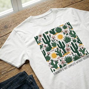 T-Shirt with Desert Plants Pattern and Quote on Strength and Delicacy image 8