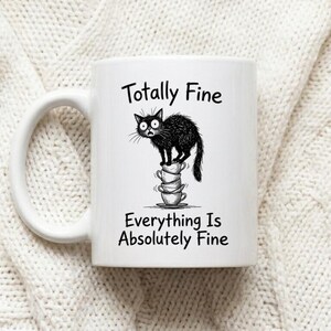 Mug Cat Balancing on Teacup Stack Totally Fine Funny Stress Humor Coffee Cup image 1