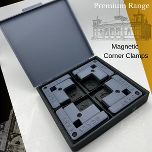 May include: A set of four magnetic corner clamps in a black case. The clamps are gray and have the words "SCALE" and "CAST" printed on them. The case has a blue lid.