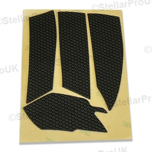 May include: A set of five black honeycomb-patterned mouse feet pads on a brown backing sheet. The pads are designed to replace worn-out mouse feet.