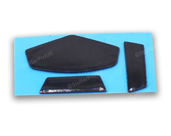 May include: Three black rubber mouse feet pads for a computer mouse. The pads are shaped like a triangle, a rectangle, and a long strip.