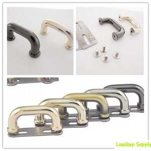 May include: Selection of metal purse handles in black, gold, silver, and bronze. The U-shaped handles are curved and attached to rectangular metal plates. Additional hardware and screws are also visible. Measurements are in centimeters.