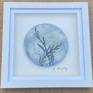 May include: A framed blue and white ceramic wall art piece with a pressed leaf design. The piece is signed "E. Murphy".
