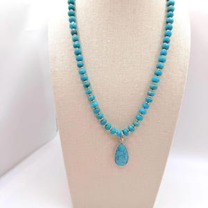 Necklace made with beads and a drop pendant made of turquoise dyed howlite, sterling silver spacer beads, and a toggle closure