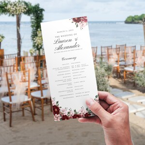 May include: Wedding ceremony program with floral design. The program lists the order of events for the wedding of Lauren & Alexander on March 1st, 2023.