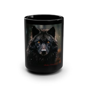 May include: Black coffee mug with a black wolf with glowing yellow eyes printed on it. The wolf is looking directly at the viewer. The mug has a black handle and a white background.