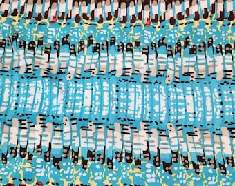May include: Abstract textile pattern featuring a vibrant mix of colors. The design includes vertical and horizontal elements in shades of blue, red, black, white, and brown. The fabric appears to have a pleated texture.