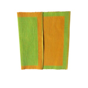 May include: A rectangular placemat featuring a ribbed texture with a color-blocked design. The left side has a lime green center bordered by orange, while the right side has an orange center bordered by lime green, creating a vibrant contrast.
