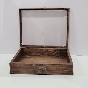May include: A dark brown wooden display case with a clear glass top. The case is open and empty.
