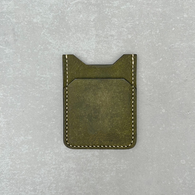 Leather card holder made of olive colored top grain Italian leather and cream colored durable Japanese thread, completely hand-sewn without using any machines. It has a soft and high-quality texture and a wonderful scent.