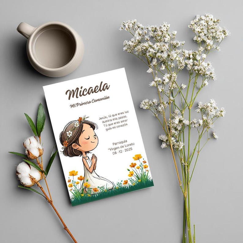 May include: A rectangular card featuring the name Micaela and the text Mi Primera Comuni&oacute;n, with an illustration of a person praying in a field of yellow flowers. The card includes additional Spanish text and the date 08-12-2025.