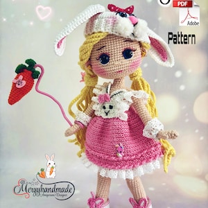 May include: A handmade crochet doll with blonde pigtails, wearing a pink dress and a bunny hat. The doll holds a carrot on a pink wire. The doll's outfit includes white lace trim and matching shoes. The image includes the text "English PDF Pattern" and a logo.