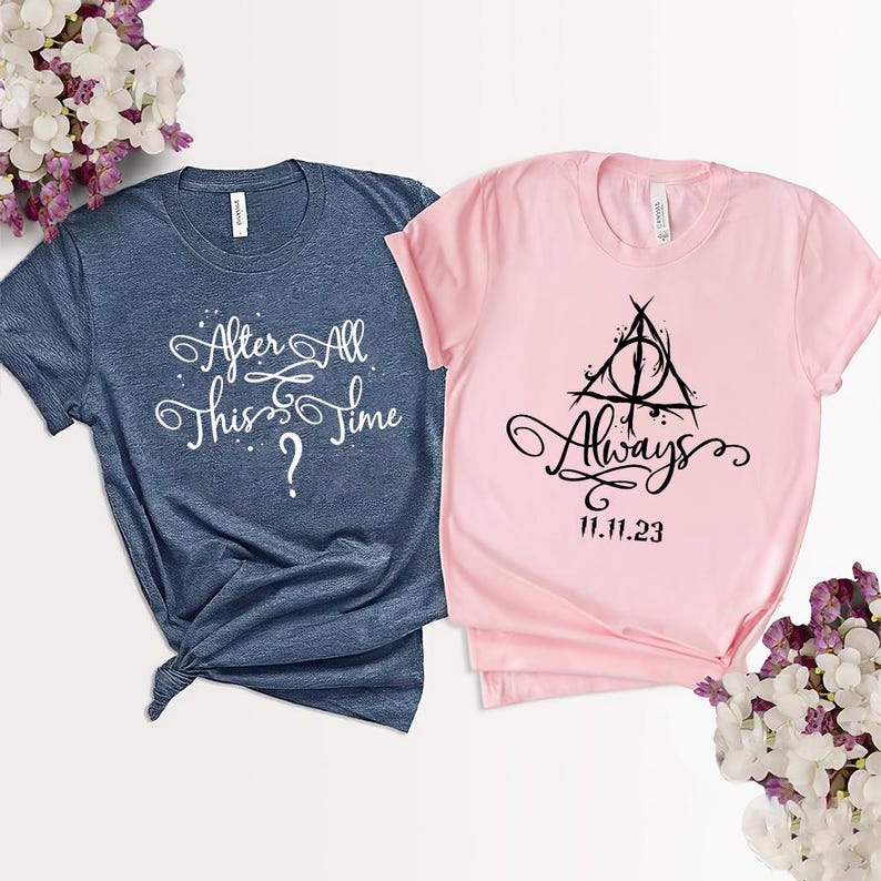 May include: Two t-shirts, one blue and one pink, with text and a graphic. The blue shirt says "After All This Time?" and the pink shirt says "Always" with a symbol of a triangle with a circle inside and the date "11.11.23".