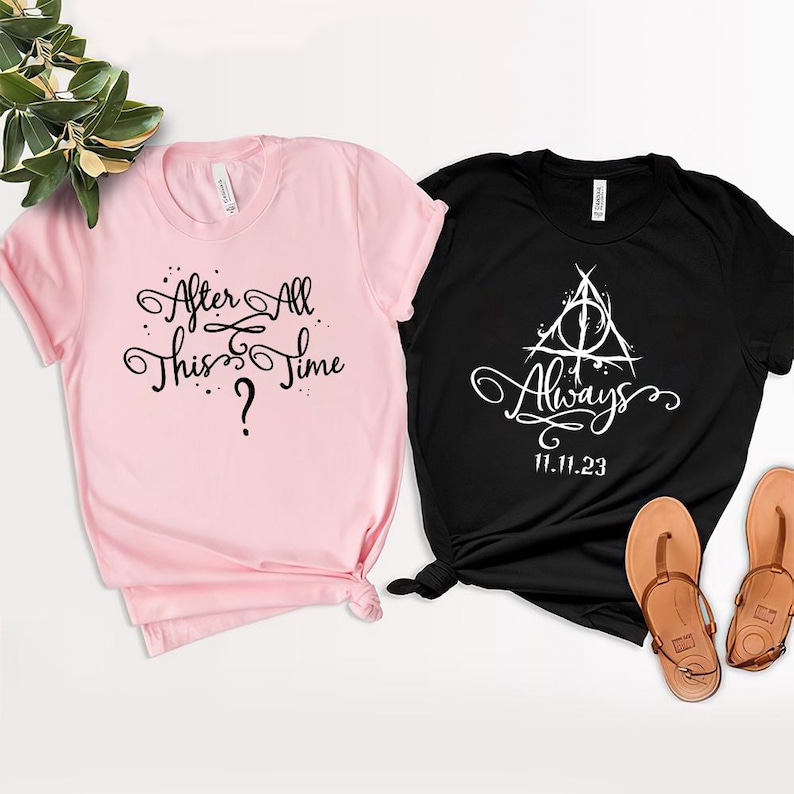 May include: Two t-shirts, one pink and one black, with text and a graphic. The pink shirt says "After All This Time?" and the black shirt says "Always" with a symbol and the date "11.11.23".