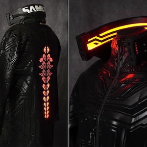 May include: Black futuristic jacket with illuminated orange accents. The jacket features a circuit board design and a glowing spine detail. A headpiece with the word "SAM" is visible.