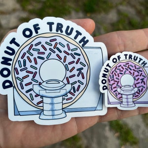 May include: Two stickers featuring a donut with sprinkles and the text "Donut of Truth". The larger sticker is a full-colour illustration, while the smaller sticker is a black and white outline.
