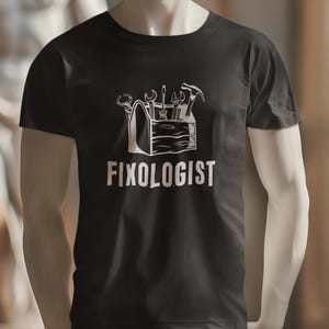Black t-shirt with a white graphic of a toolbox with tools and the text "Fixologist".