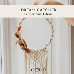 May include: A macrame dream catcher featuring a circular frame wrapped in off-white cord, adorned with dried orange and tan flowers on the left side. The text DREAM CATCHER DIY Macrame Tutorial and the brand name noué are visible on the image.