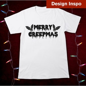 May include: White t-shirt with black text that reads "Merry Creepmas" with dripping letters and skulls on either side of the word "Merry".