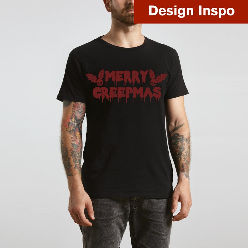 May include: A black t-shirt with a red dripping text design that says "Merry Creepmas" with a skull and holly leaf on either side of the text.
