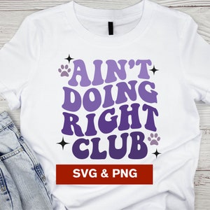 May include: White t-shirt with a purple and white gradient design that says "Ain't Doing Right Club" with paw prints and stars. The text is in a retro font. The bottom of the shirt has a red banner that says "SVG & PNG".