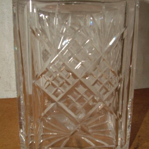 May include: A clear glass decanter with a square body and a diamond-shaped pattern etched into the glass.