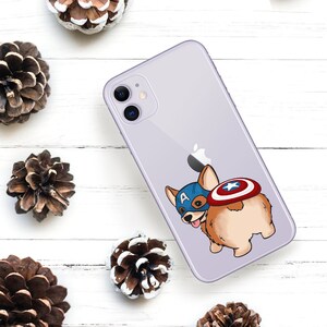 May include: A purple iPhone case with a cartoon image of a corgi wearing a Captain America costume. The corgi is holding a shield behind its back.