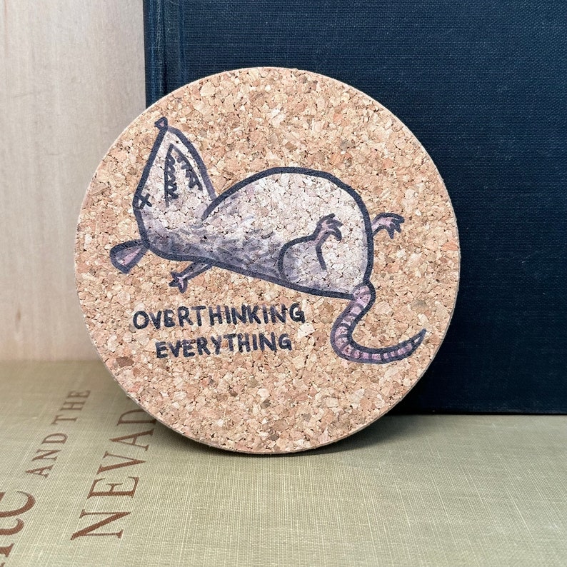 round coaster with an exhausted possum saying over thinking everything