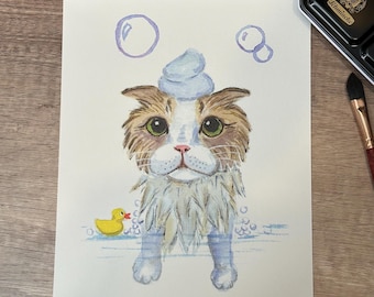 May include: A watercolor painting of a cat with a white towel on its head, taking a bath. The cat is surrounded by bubbles and a yellow rubber ducky is floating in the water.
