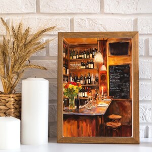 May include: A painting of a bar interior with a wooden counter, shelves stocked with wine bottles, and a chalkboard menu. The bar is lit by warm, yellow light, and there are two stools at the counter. The painting is framed in a brown wooden frame.