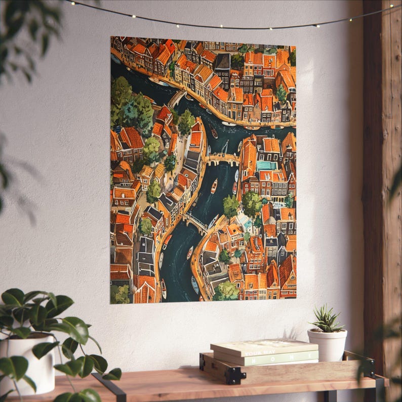 May include: An aerial view of a city with narrow canals and colourful buildings. The buildings are mostly brick and have red tile roofs. The canals are lined with trees and there are boats in the water.