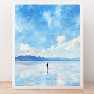 May include: A lone figure stands in the middle of a vast, reflective salt flat. The sky is a bright blue with fluffy white clouds. The mountains in the distance are barely visible.