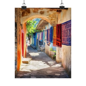 May include: A narrow, cobbled alleyway in a colourful town. The walls are painted in shades of orange, yellow, and blue.  Colourful woven rugs hang from the walls, creating a vibrant display.