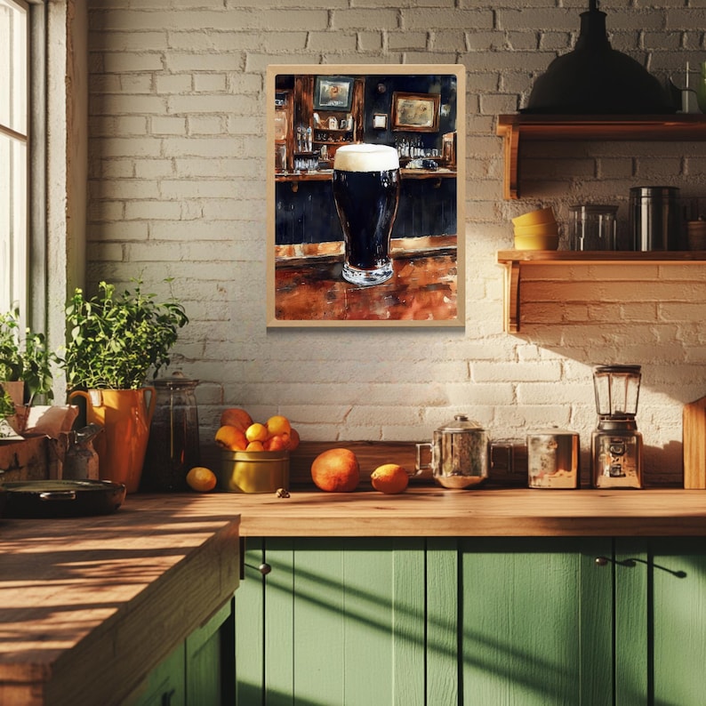 May include: A framed watercolor painting of a pint of dark beer with a thick white head, set on a wooden bar. The background depicts a dimly lit pub interior with bottles and decor.