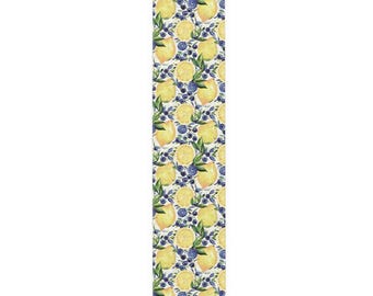 May include: A rectangular table runner with a repeating pattern of yellow lemons, blue blueberries, and green leaves on a white background. The design is a watercolor style, with a fresh, summery feel.
