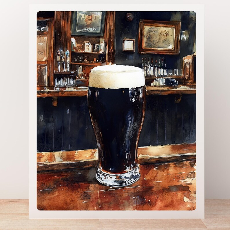 May include: Watercolor painting of a pint of dark stout beer with a thick, creamy head. The glass sits on a wooden bar in a pub setting, with dark wood paneling and framed pictures in the background.