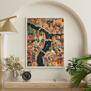 May include: A watercolour painting depicting an aerial view of a city with canals and bridges. The buildings are painted in shades of orange, red, and brown. The canals are a deep blue colour.