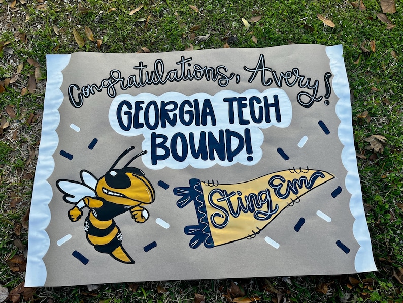 May include: A brown banner with the text "Congratulations, Avery!" and "GEORGIA TECH BOUND!" in black and white. A yellow and black cartoon hornet and a yellow pennant that says "Sting Em" are also featured.